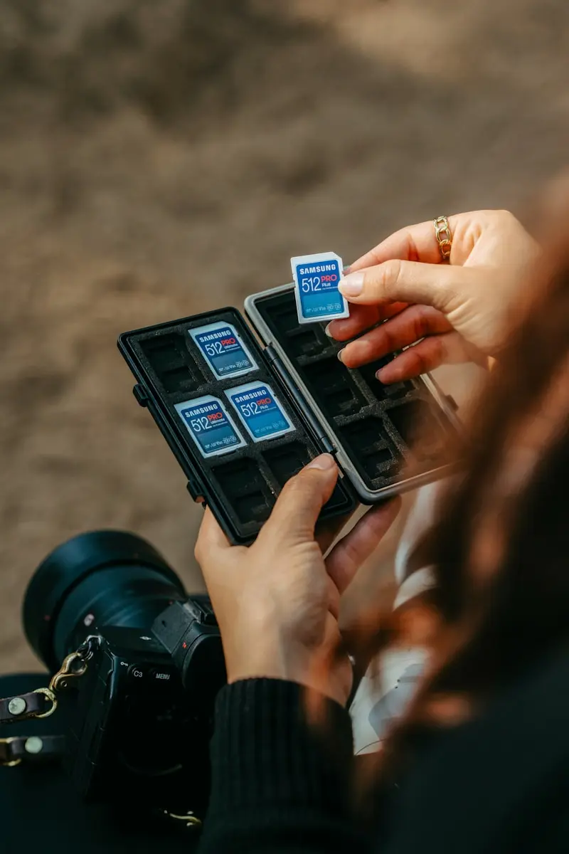 Hands placing sd card into memory card holder